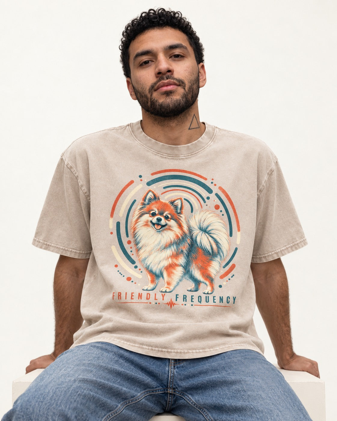 Friendly Frequency Pomeranian Washed Tee in Apricot, worn by a seated model