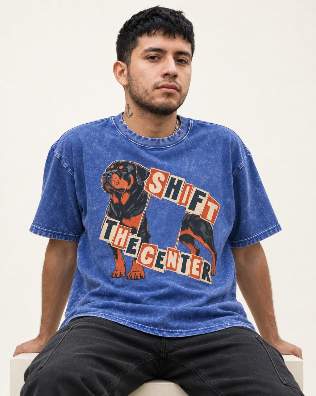 Rottweiler Shift the Center Cutout Letter Graphic Washed Tee in Royal Blue, worn by a seated model