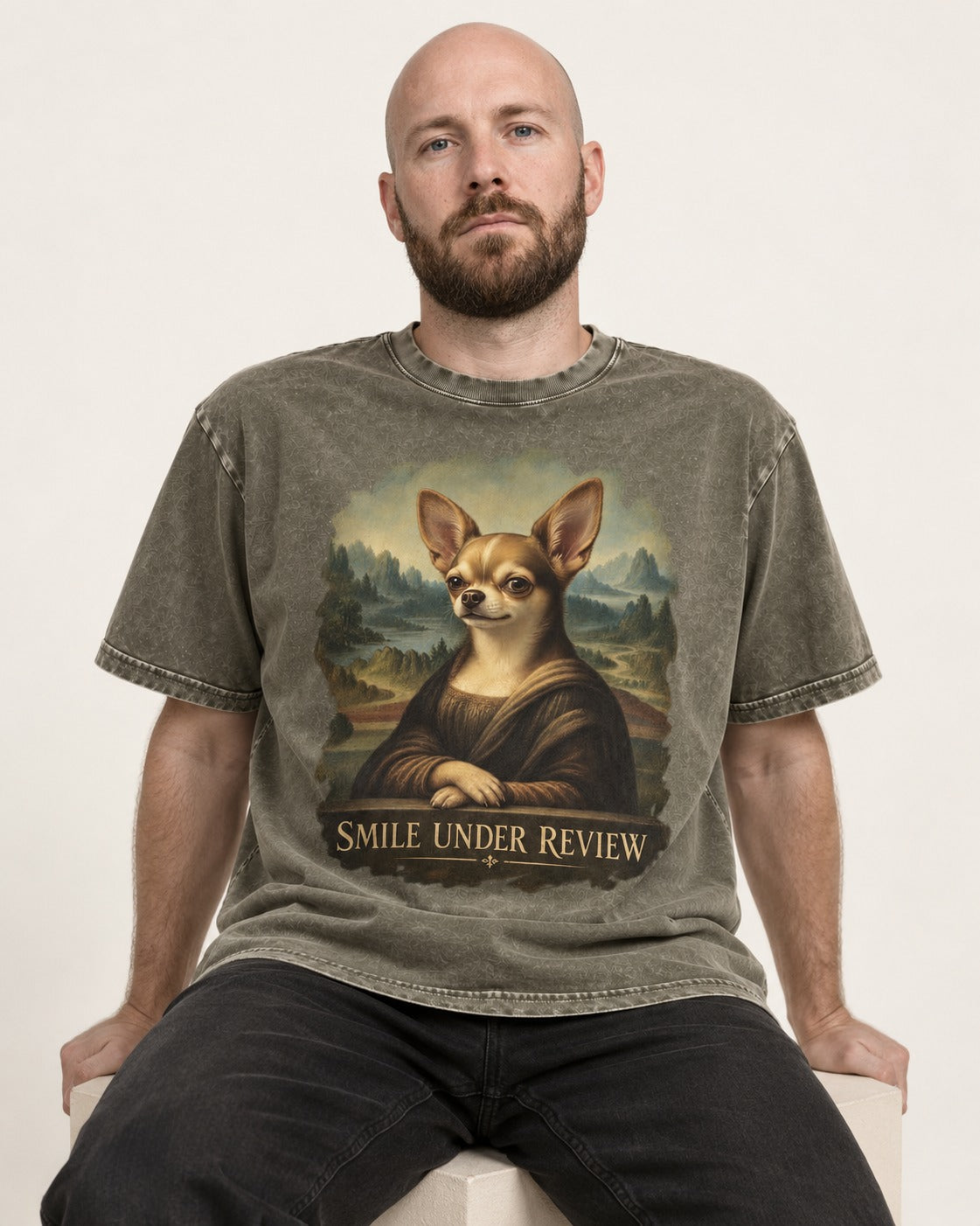 Chihuahua Smile Under Review Mona Lisa Portrait Washed Tee in Army Green, worn by a seated model