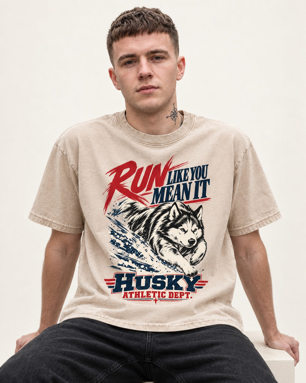 Husky Run with Purpose Washed Tee in Apricot, worn by a seated model