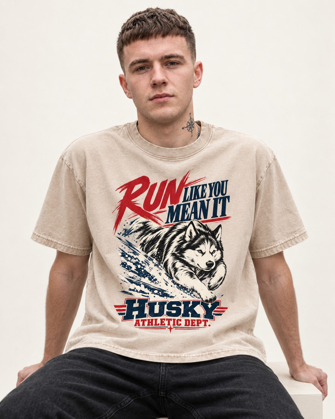 Husky Run with Purpose Washed Tee in Apricot, worn by a seated model
