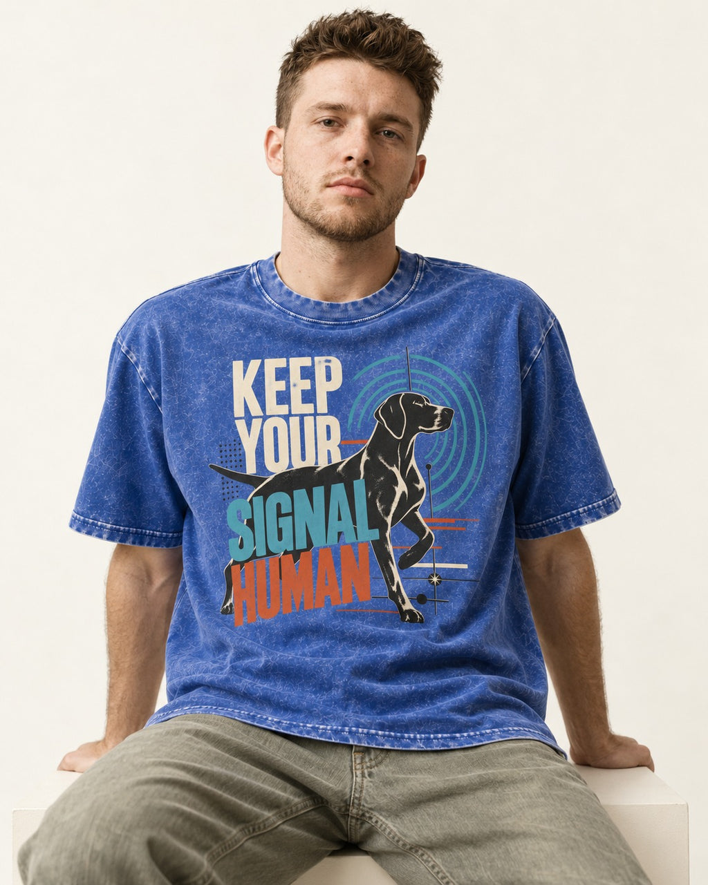 German Shorthaired Pointer Keep Your Signal Human Broadcast Graphic Washed Tee in Royal Blue, worn by a seated model