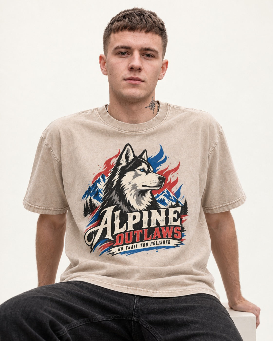 Husky Alpine Outlaws No Trail Too Polished Graphic Washed Tee in Apricot, worn by a seated model