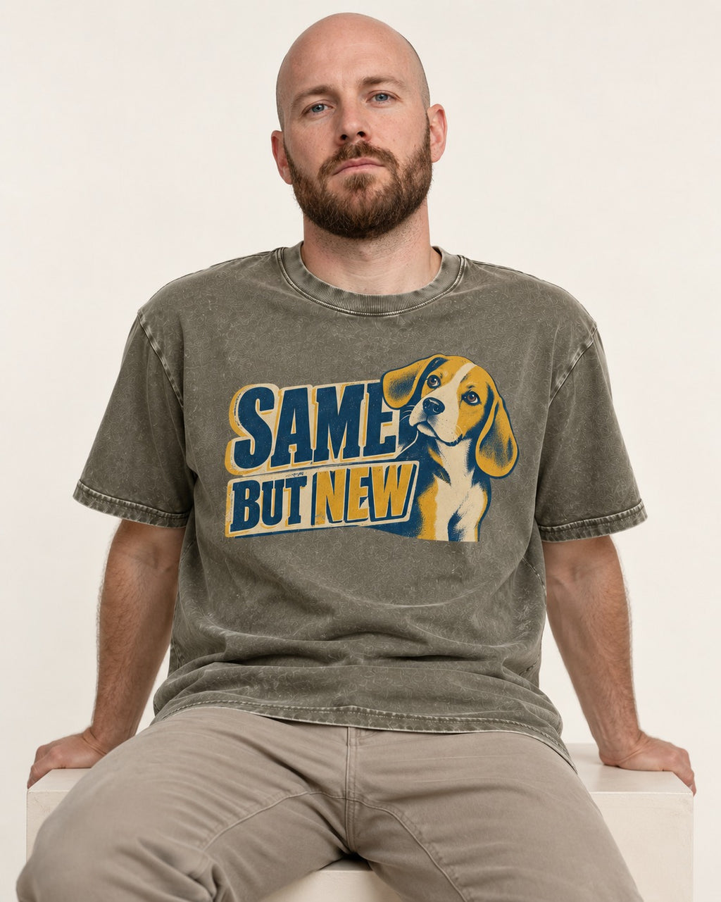Same Beagle But New Washed Tee in Army Green, worn by a seated model