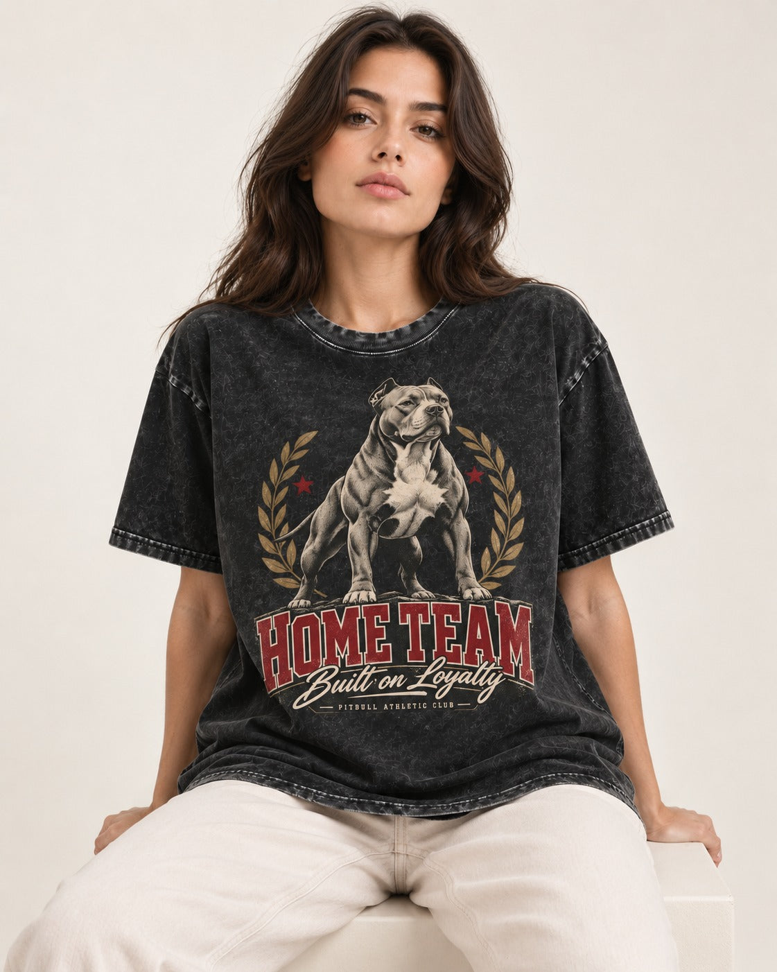 Pitbull Home Team Loyalty Crest Graphic Washed Tee in Black, worn by a seated model