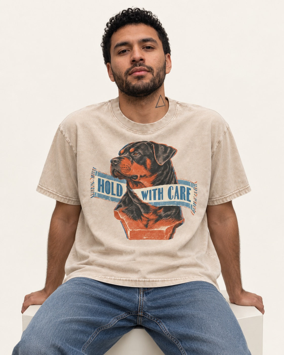 Rottweiler Hold with Care Washed Tee in Apricot, worn by a seated model