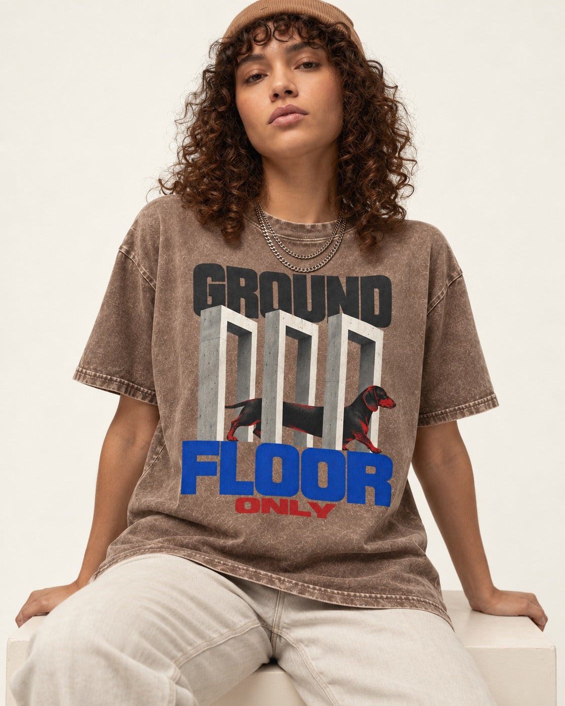 Ground Floor Only Dachshund Washed Tee in Coffee, worn by a seated model
