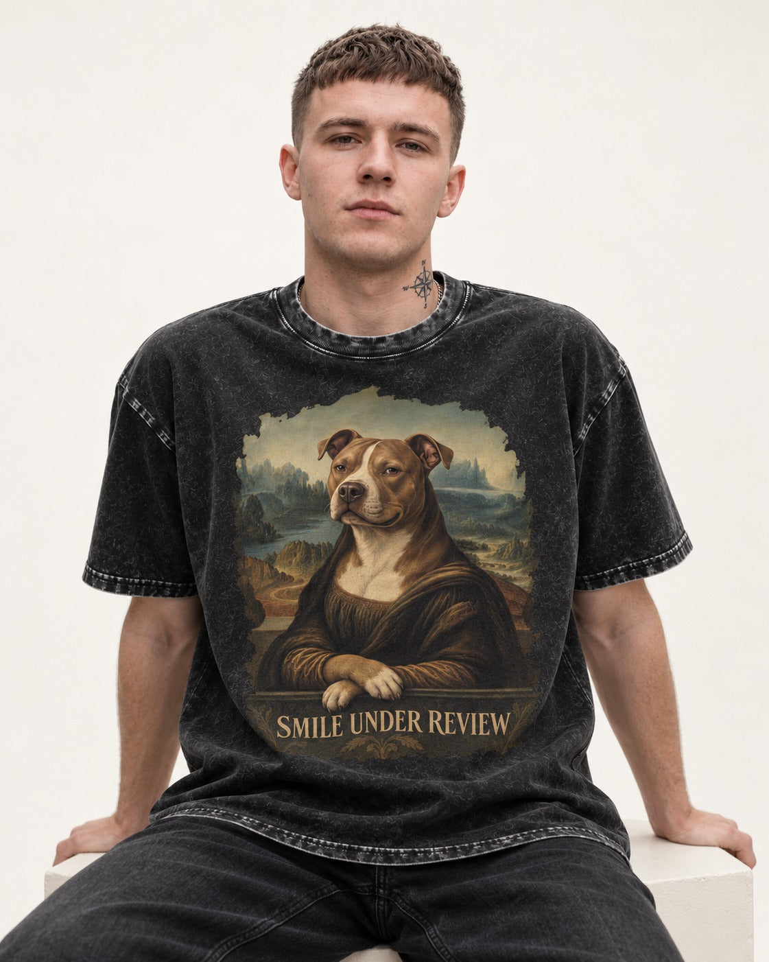 Pitbull Smile Under Review Renaissance Portrait Graphic Washed Tee in Black, worn by a seated model