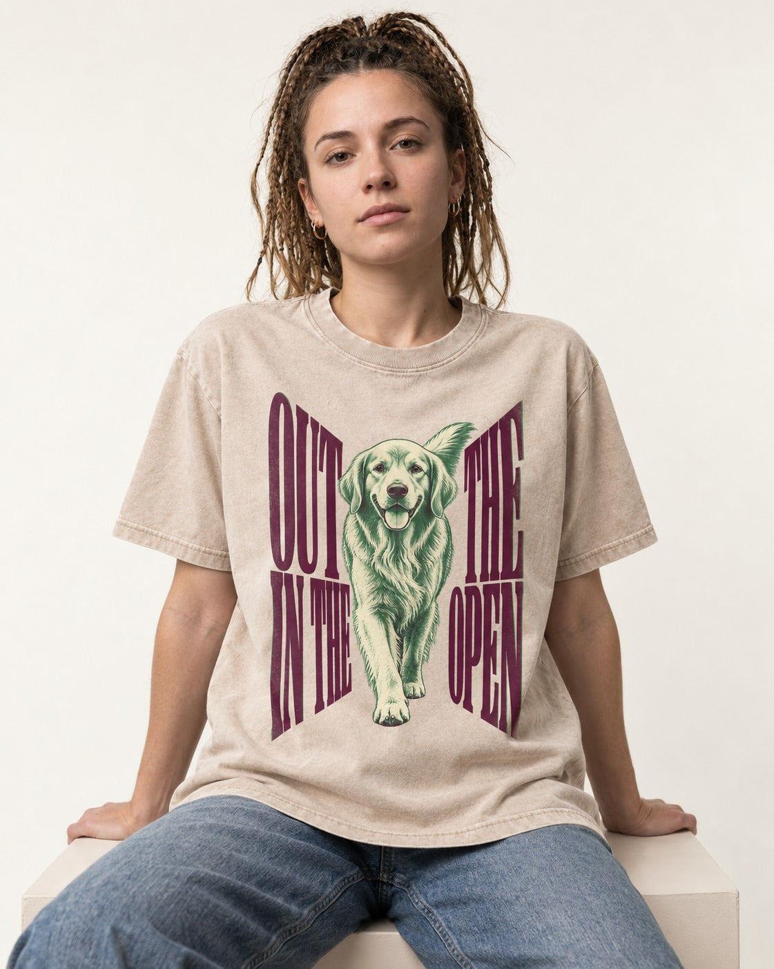 Golden Retriever Out in the Open Washed Tee in Apricot, worn by a seated model