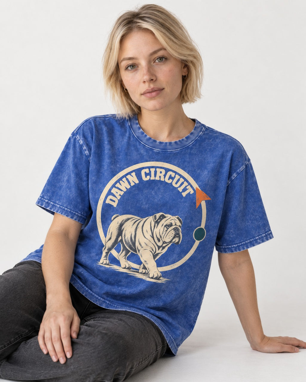 English Bulldog Dawn Circuit Emblem Washed Tee in Royal Blue, worn by a seated model