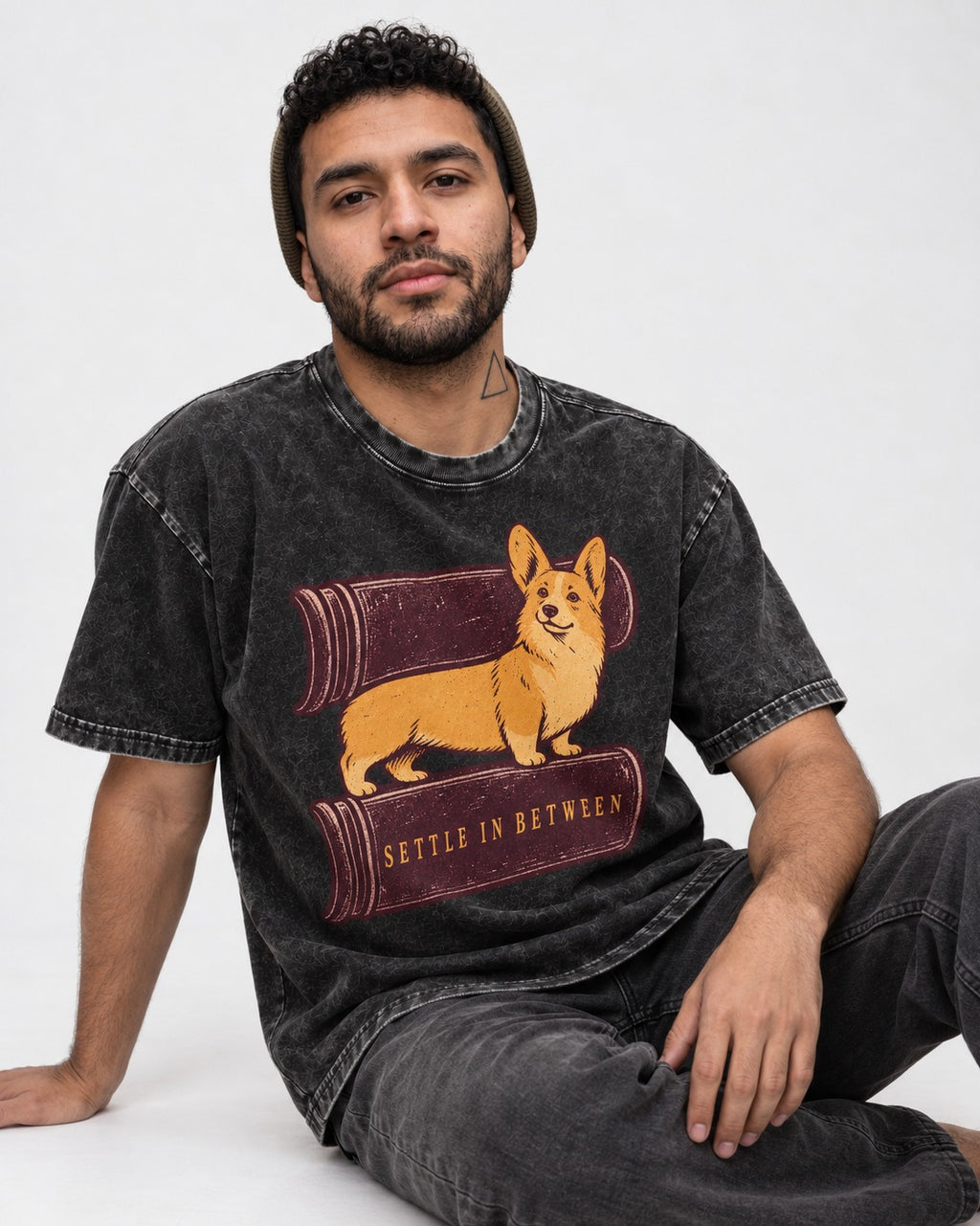 Corgi Settle in Between Washed Tee in Black, worn by a seated model