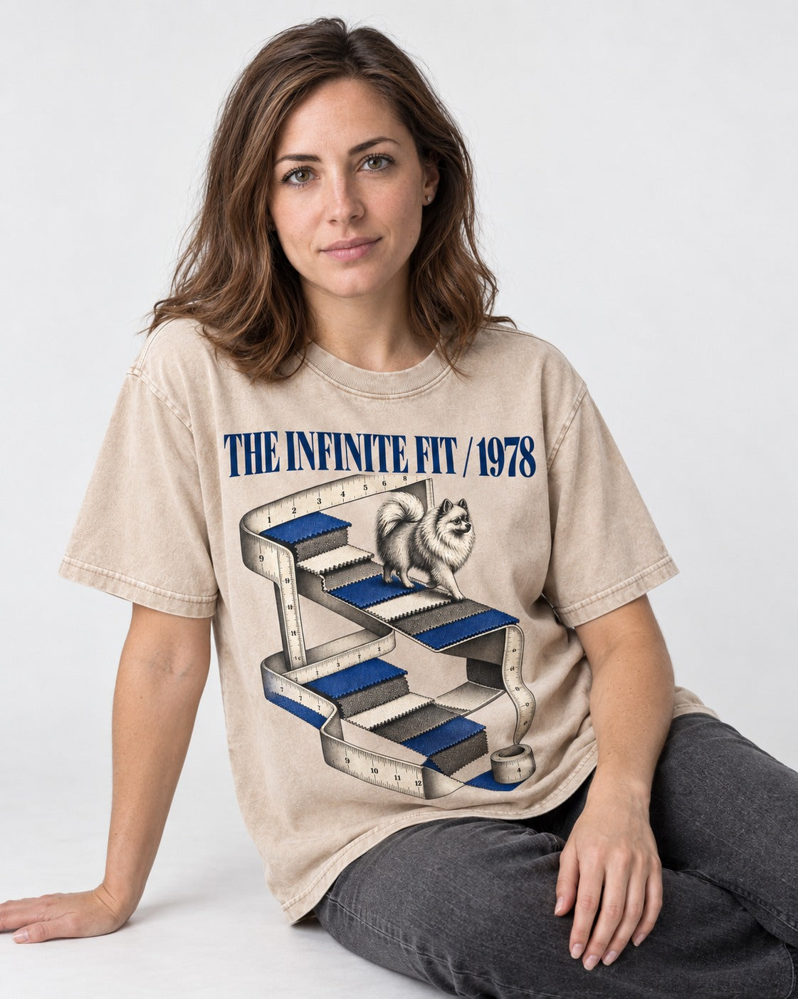 The Infinite Pomeranian Fit Washed Tee in Apricot, worn by a seated model