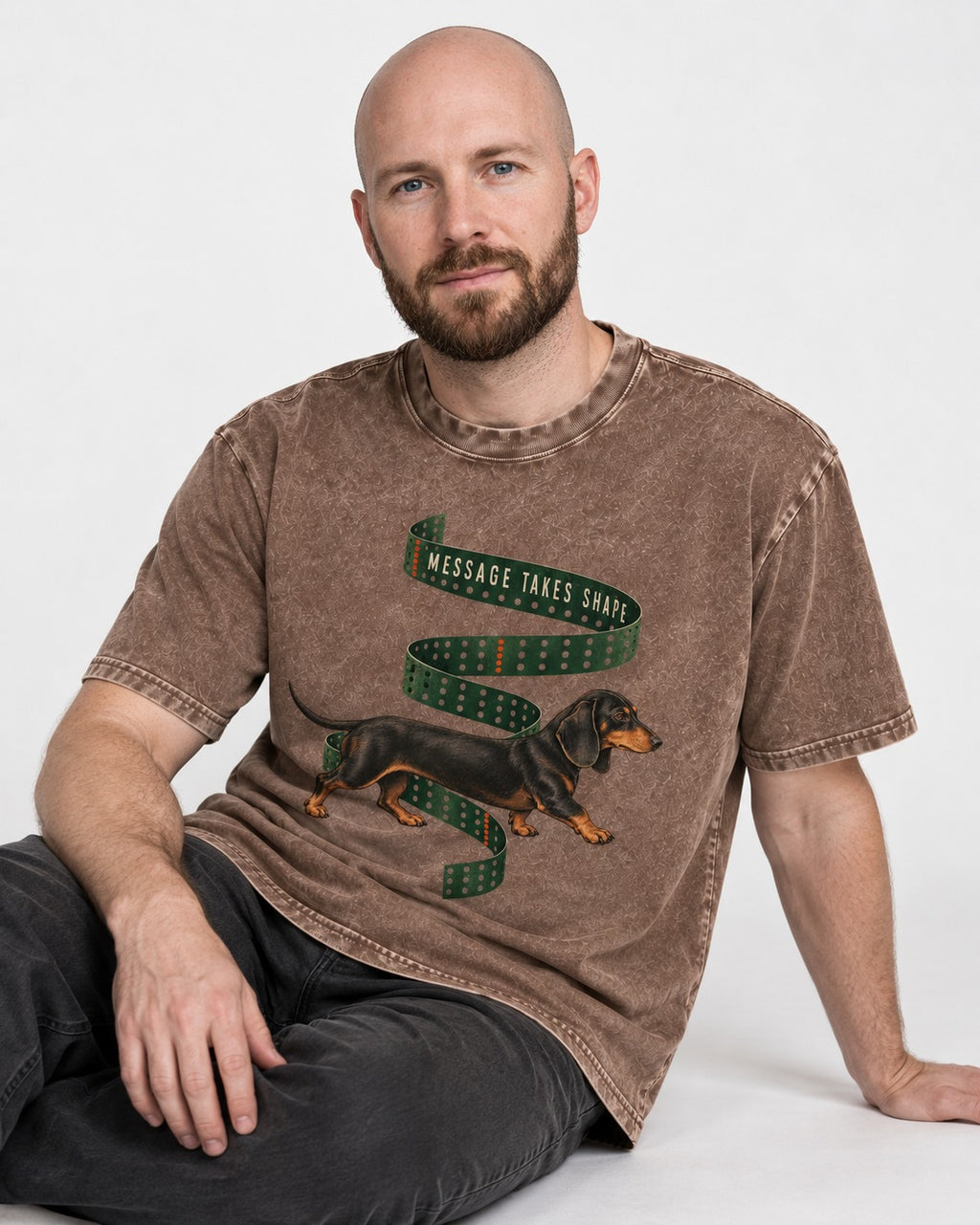 Dachshund Message Takes Shape Washed Tee in Coffee, worn by a seated model