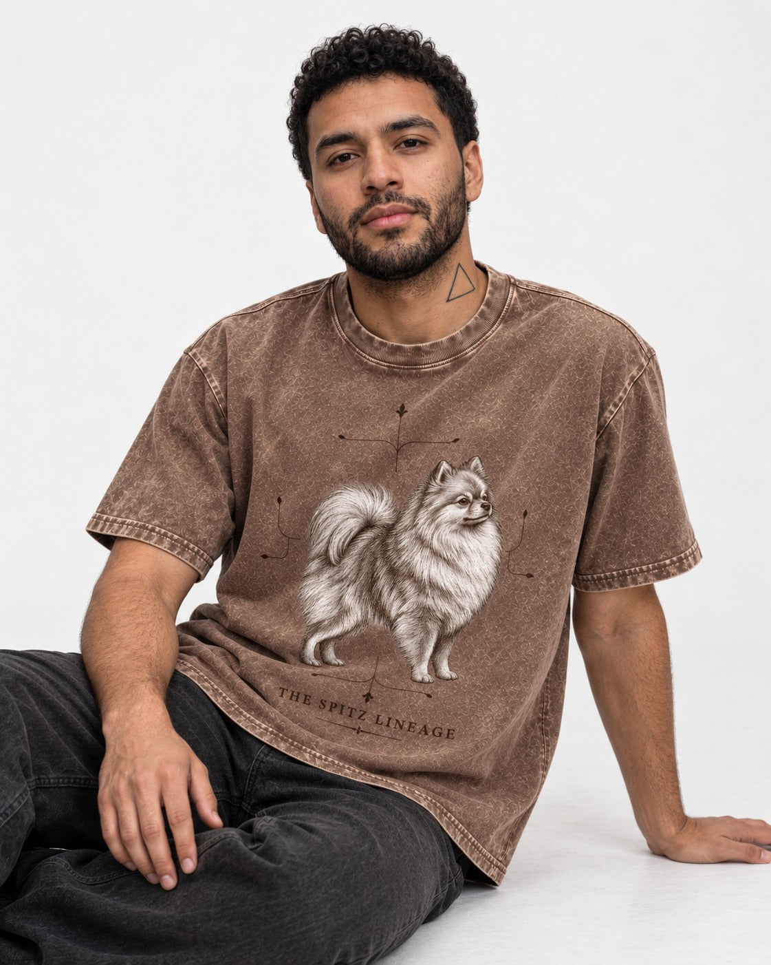 Pomeranian Spitz Lineage Washed Tee in Coffee, worn by a seated model