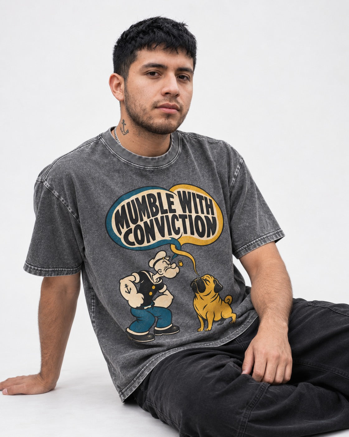 Pug Mumble with Conviction Washed Tee in Gray, worn by a seated model