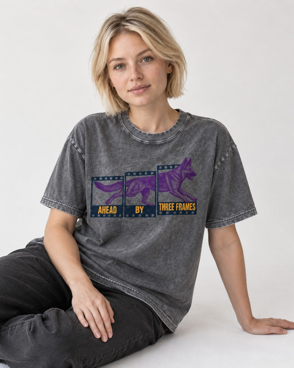 German Shepherd Dog Ahead by Three Frames Washed Tee in Gray, worn by a seated model