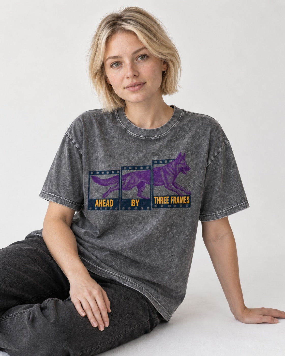 German Shepherd Dog Ahead by Three Frames Washed Tee in Gray, worn by a seated model