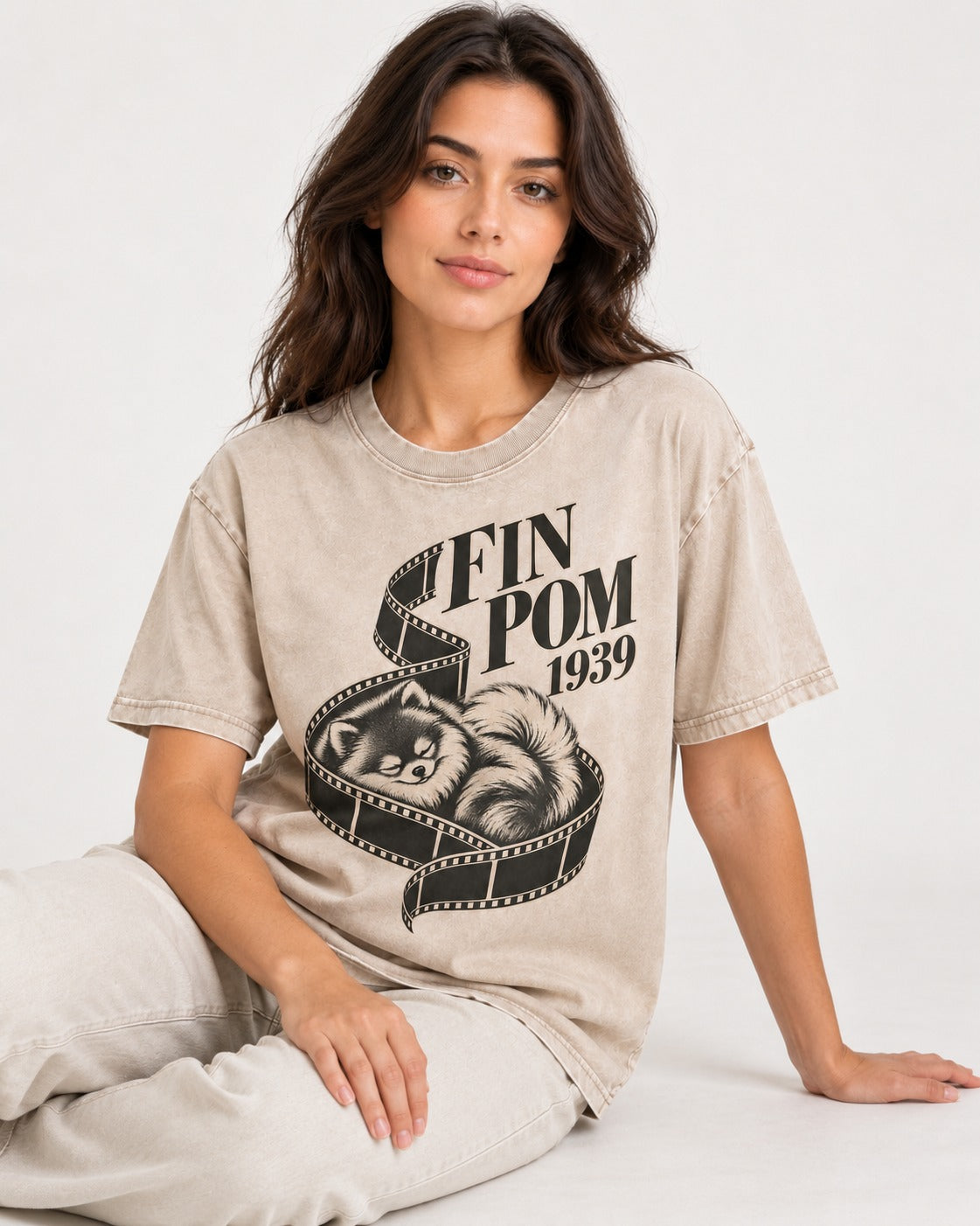 Fin Pomeranian Washed Tee in Apricot, worn by a seated model