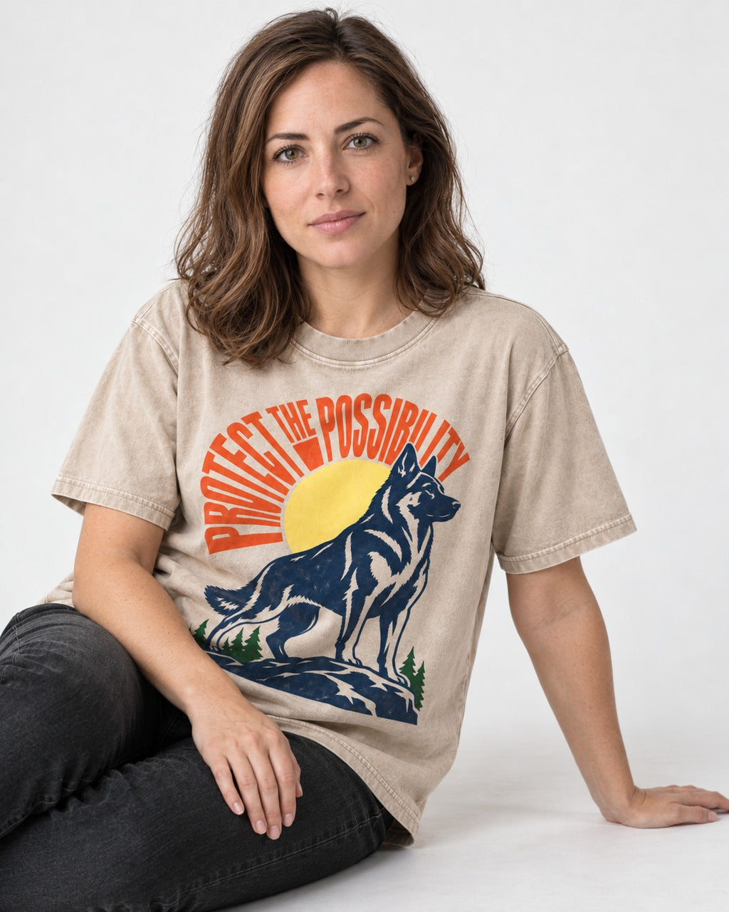 German Shepherd Dog Protect the Possibility Washed Tee in Apricot, worn by a seated model