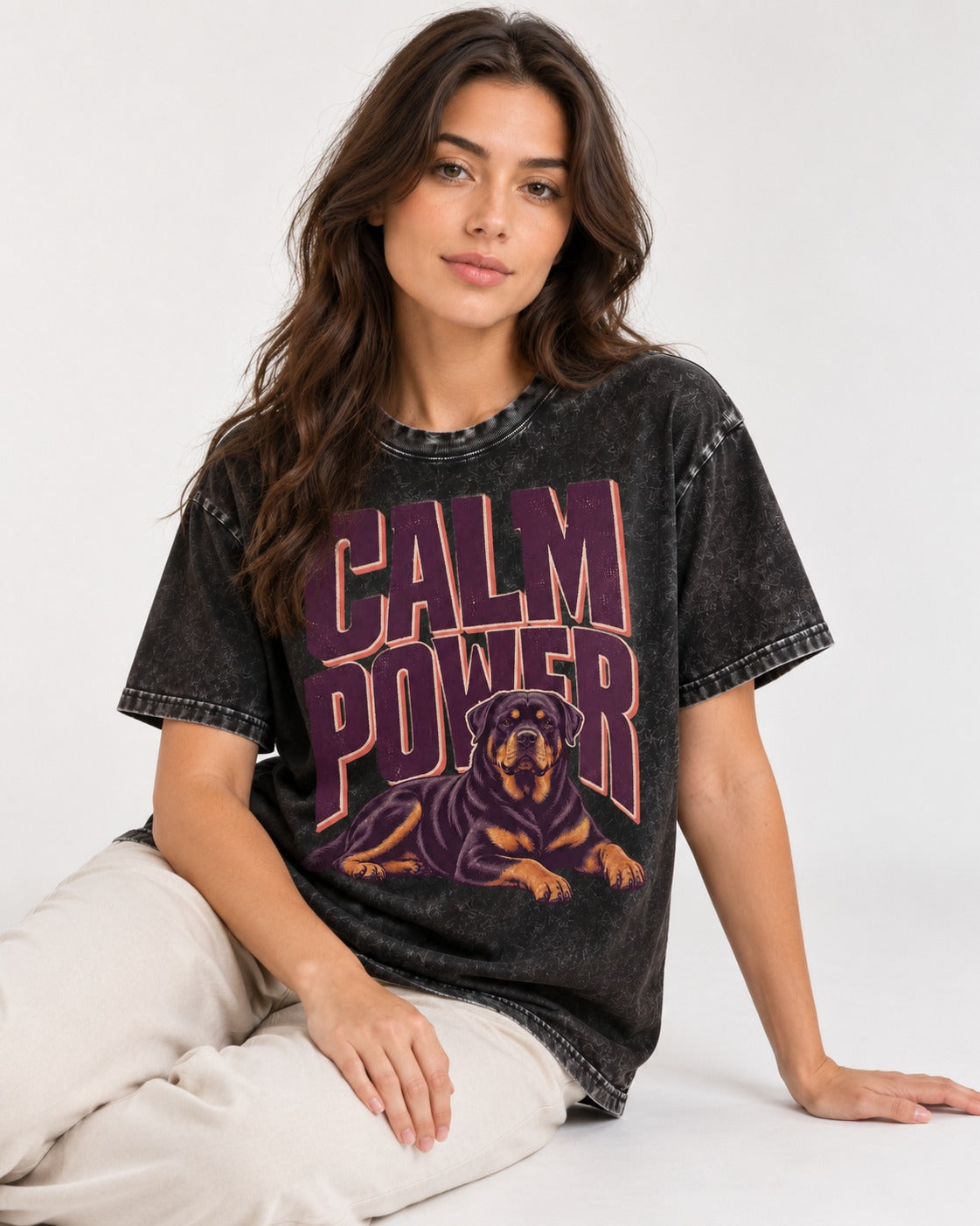 Rottweiler Calm Power Resting Dog Graphic Washed Tee in Black, worn by a seated model
