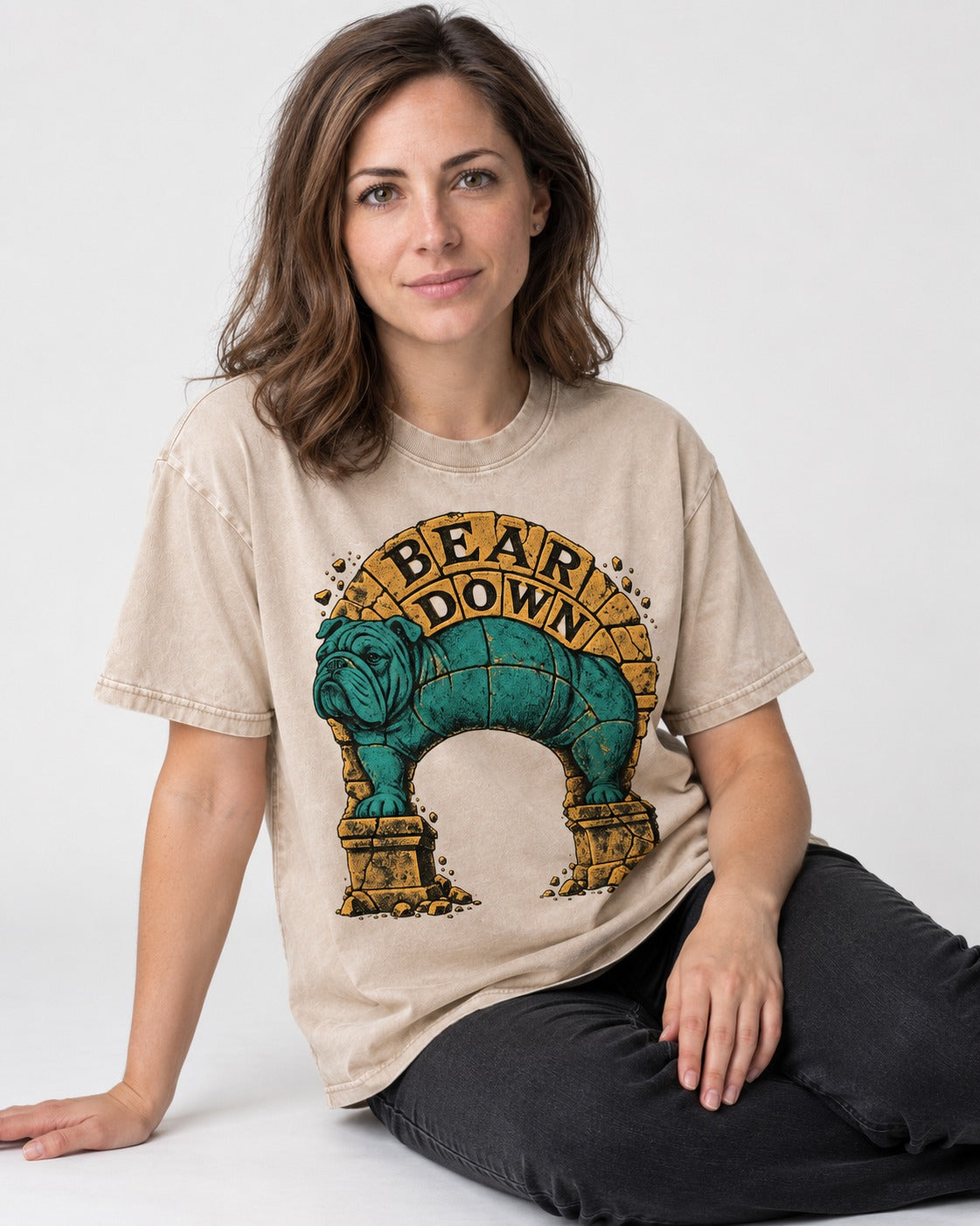 English Bulldog Bear Down Stone Arch Graphic Washed Tee in Apricot, worn by a seated model
