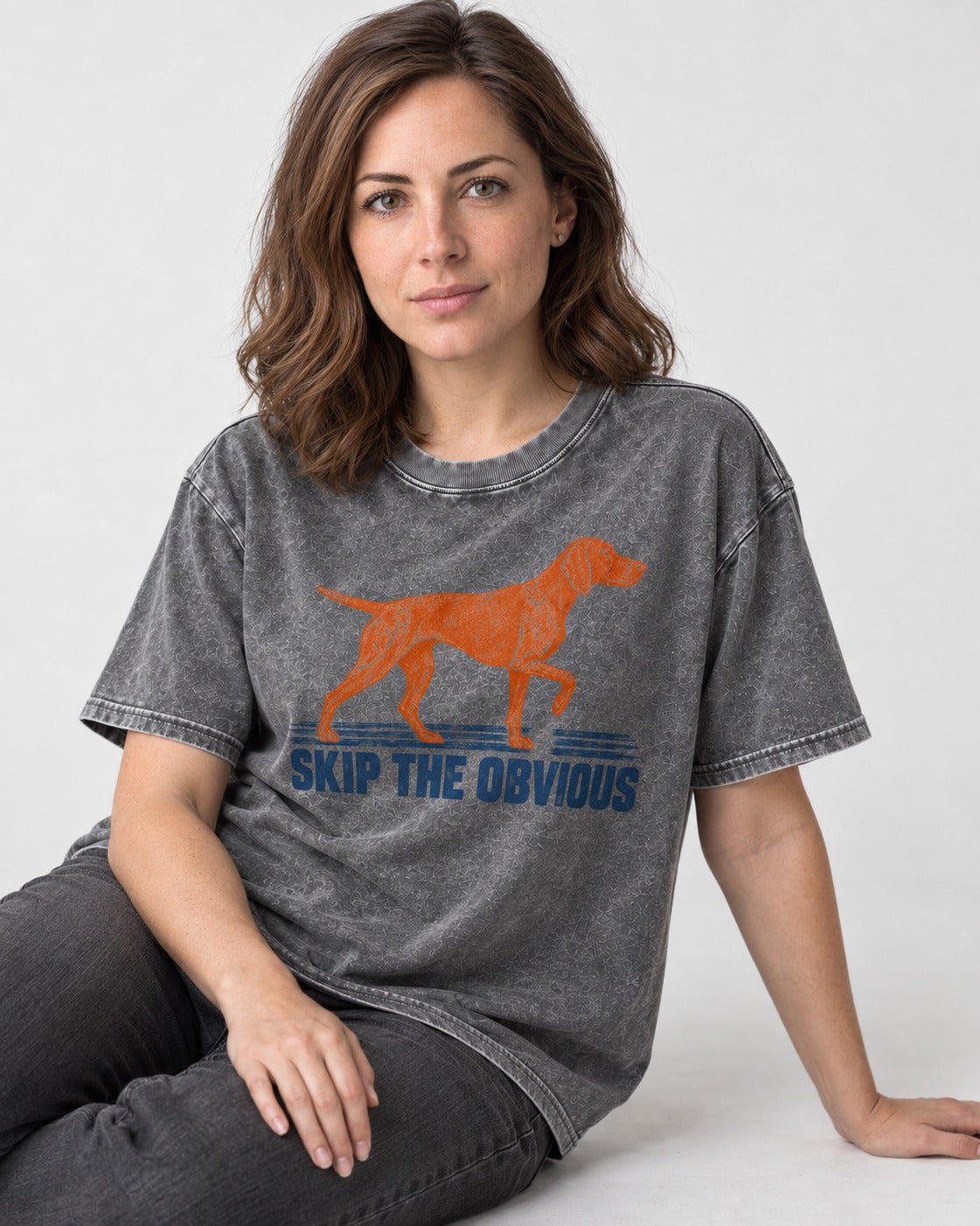 Skip the Obvious German Shorthaired Pointer Washed Tee in Gray, worn by a seated model