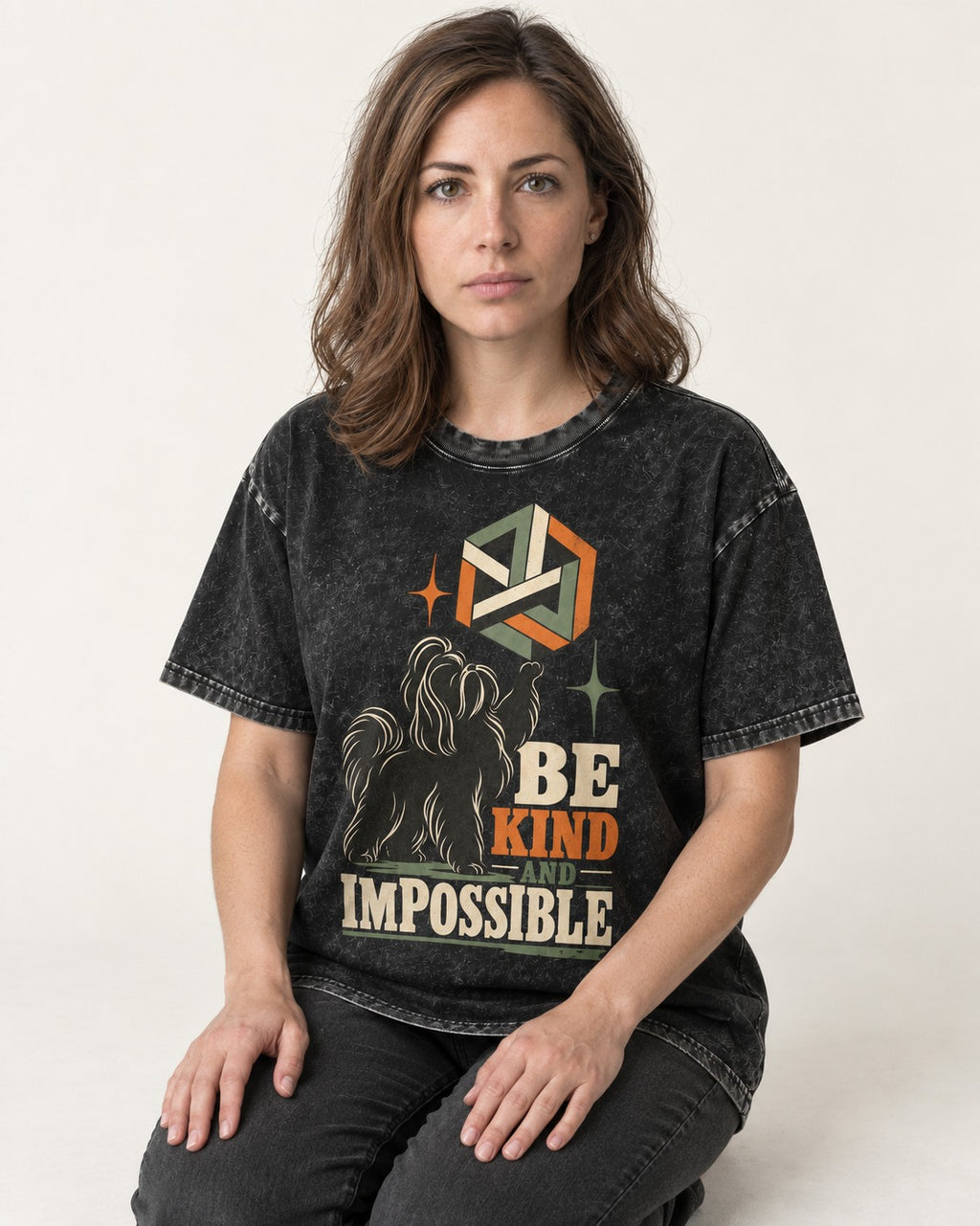 Shih Tzu Be Kind and Impossible Geometric Cube Graphic Washed Tee in Black, worn by a seated model