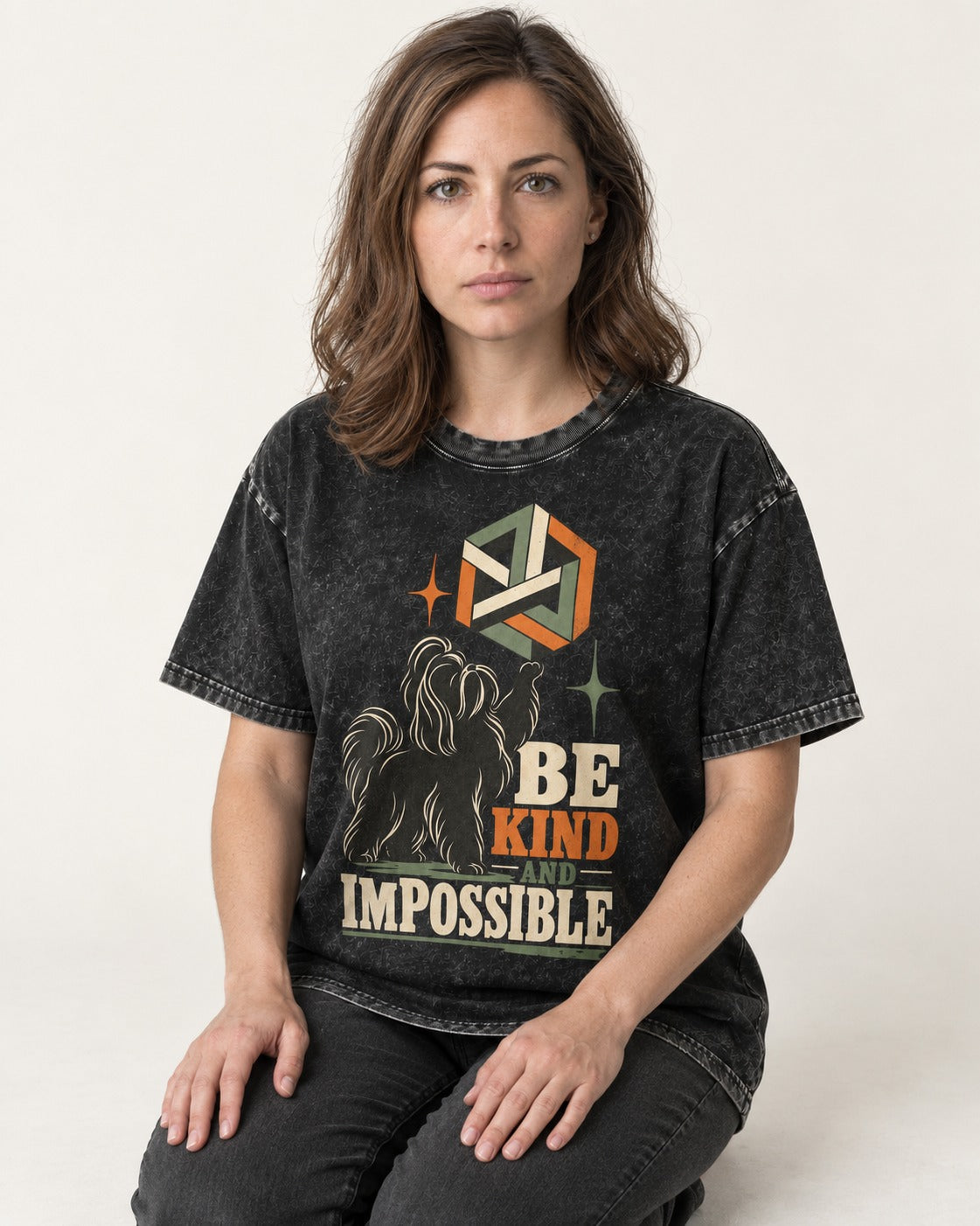 Shih Tzu Be Kind and Impossible Geometric Cube Graphic Washed Tee in Black, worn by a seated model
