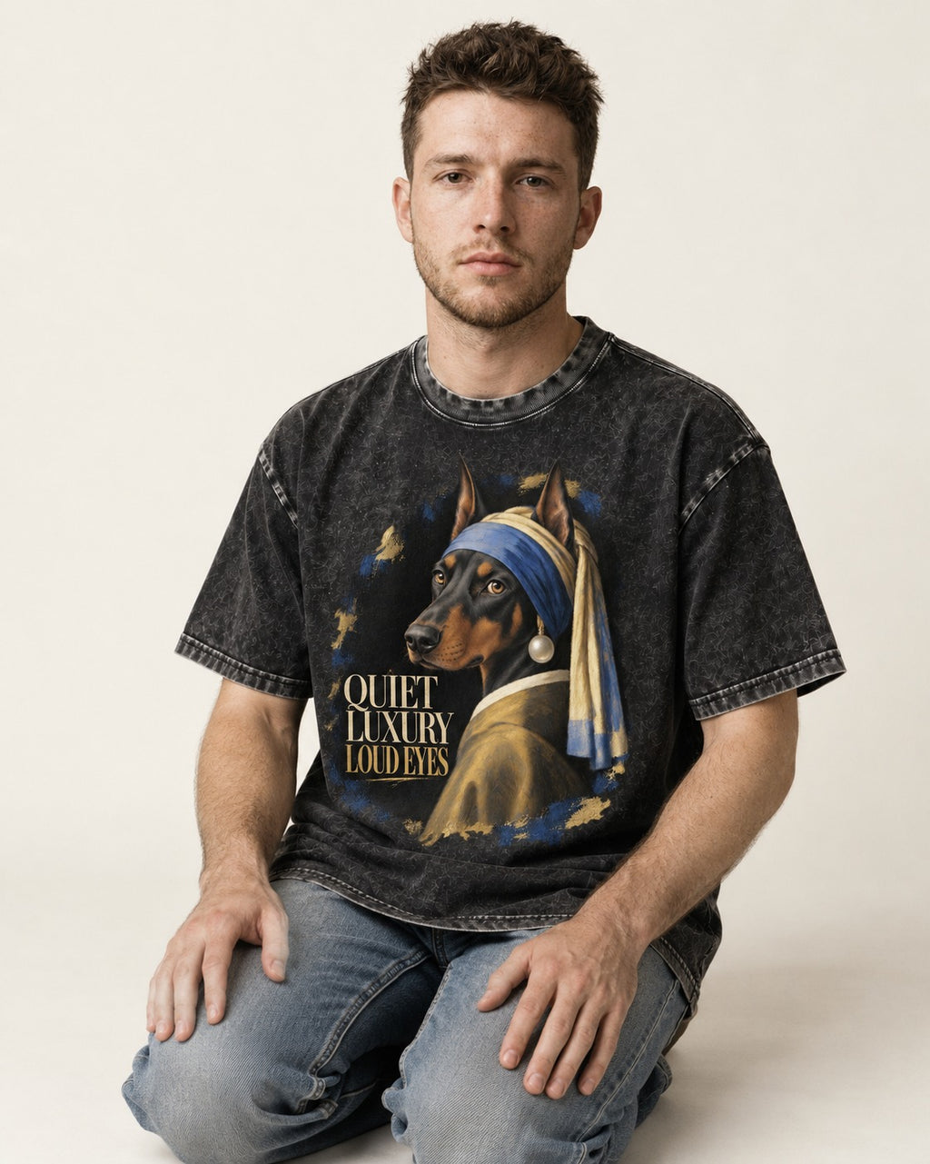 Doberman Quiet Luxury Loud Eyes Pearl Portrait Graphic Washed Tee in Black, worn by a seated model