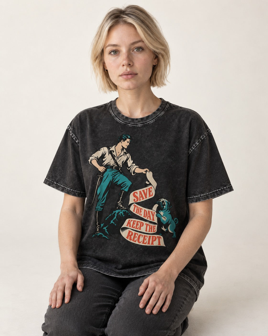 Pug Save the Day Keep the Receipt Hero Graphic Washed Tee in Black, worn by a seated model