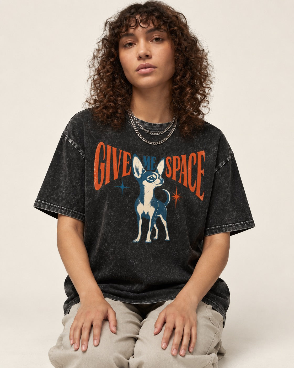 Chihuahua Give Me Space Starburst Graphic Washed Tee in Black, worn by a seated model