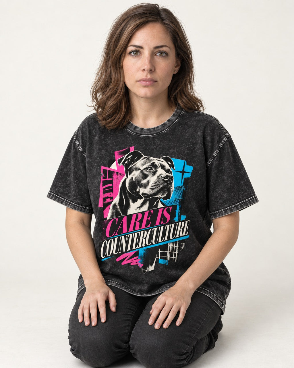 Pitbull Care Is Counterculture Neon Collage Portrait Graphic Washed Tee in Black, worn by a seated model