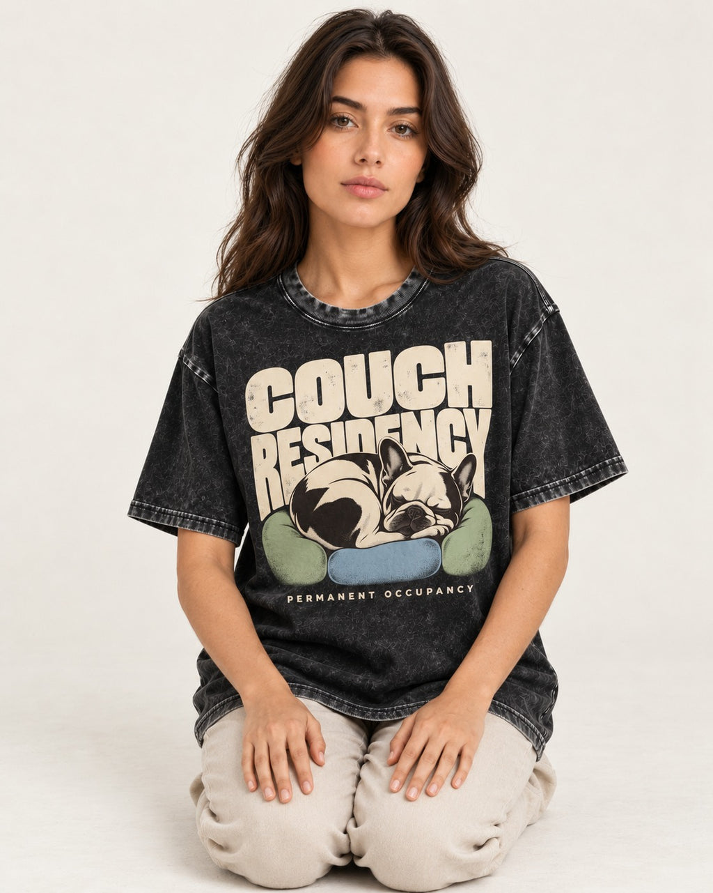Frenchie Couch Residency Permanent Occupancy Cushion Graphic Washed Tee in Black, worn by a seated model