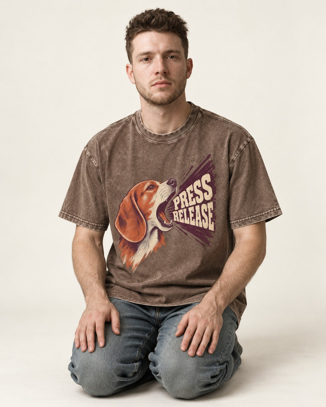 Beagle Press Release Washed Tee in Coffee, worn by a seated model