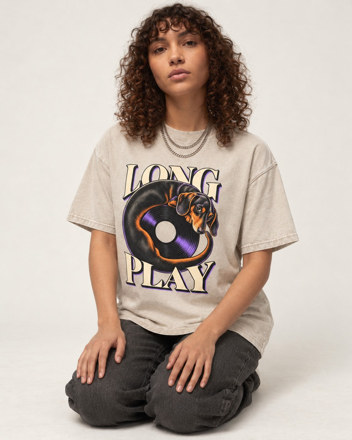 Dachshund Long Play Vinyl Record Graphic Washed Tee in Apricot, worn by a seated model