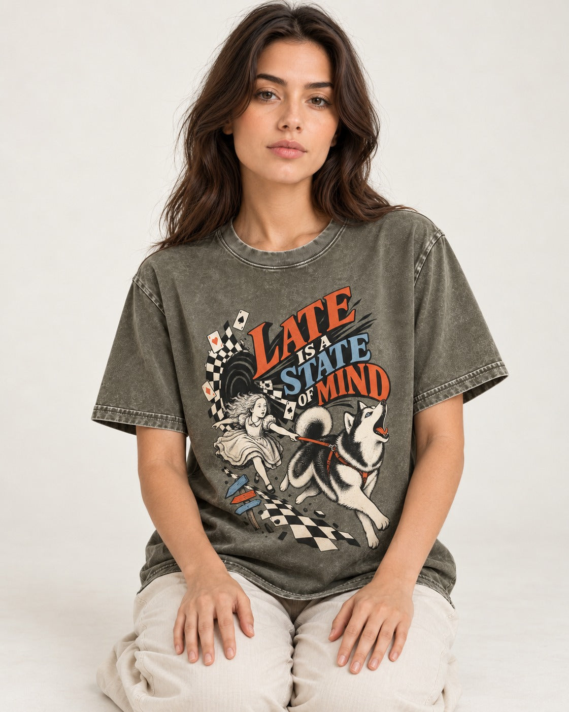 Husky Late Is a State of Mind Wonderland Chase Graphic Washed Tee in Army Green, worn by a seated model