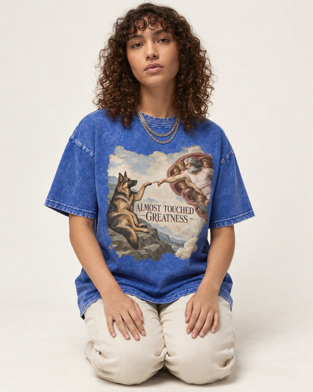 German Shepherd Dog Almost Touched Greatness Creation Parody Washed Tee in Royal Blue, worn by a seated model