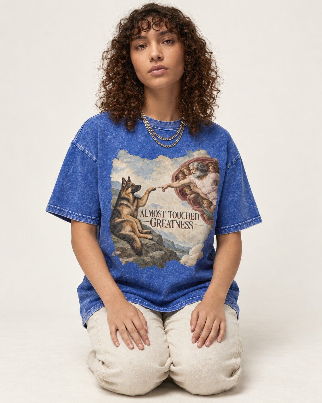 German Shepherd Dog Almost Touched Greatness Creation Parody Washed Tee in Royal Blue, worn by a seated model