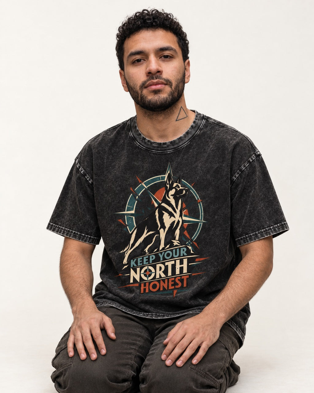 Keep Your North Honest Compass German Shepherd Dog Graphic Washed Tee in Black, worn by a seated model