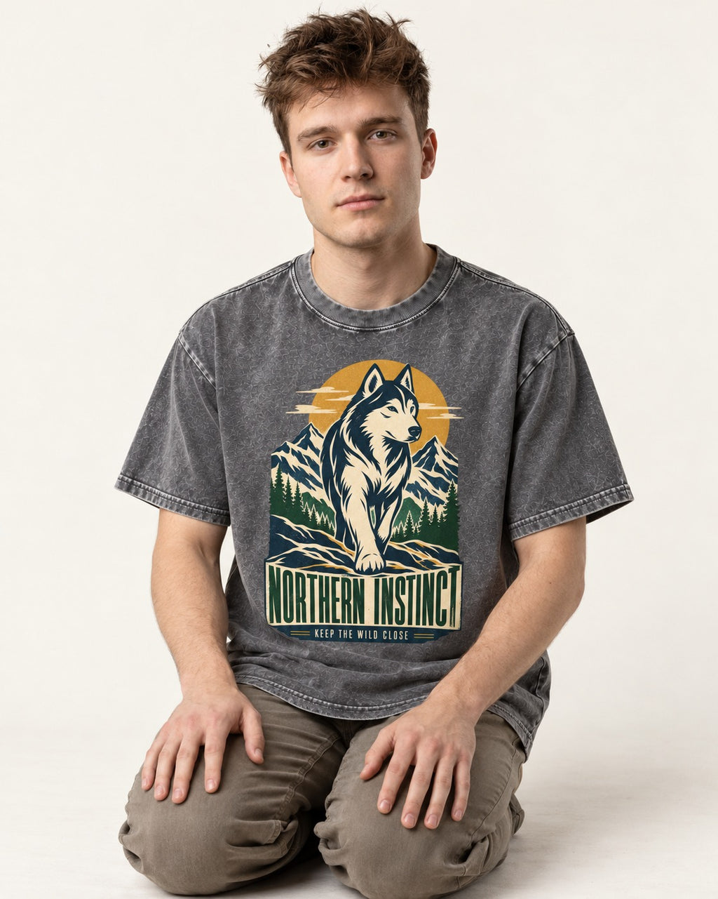 Husky Northern Instinct Mountain Sentinel Washed Tee in Gray, worn by a seated model