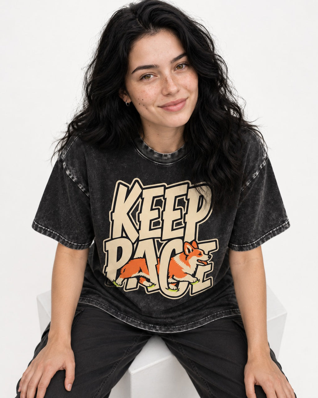 Corgi Keep Pace Running Typographic Graphic Washed Tee in Black, worn by a seated model