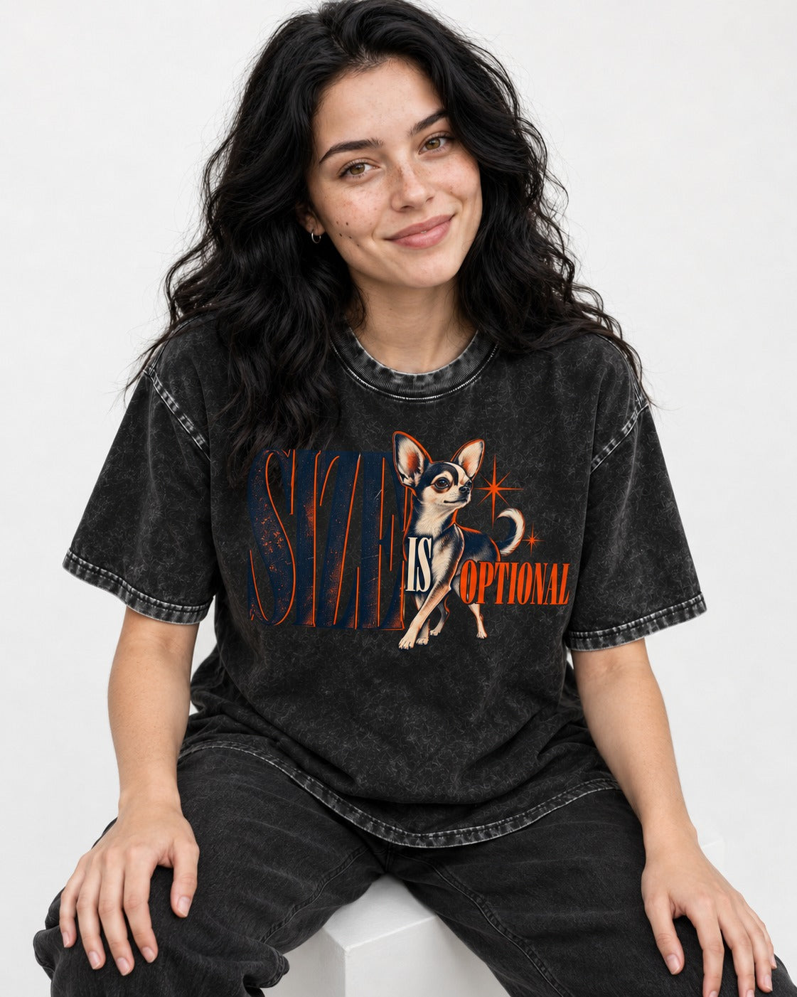 Chihuahua Size Is Optional Starburst Graphic Washed Tee in Black, worn by a seated model