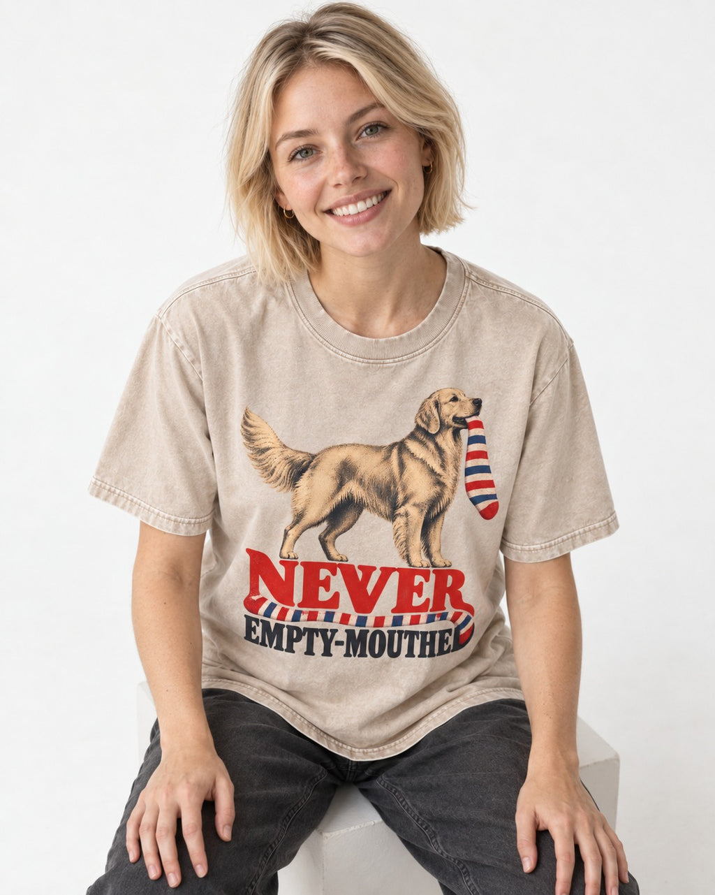 Never Empty Mouthed Golden Retriever Washed Tee in Apricot, worn by a seated model