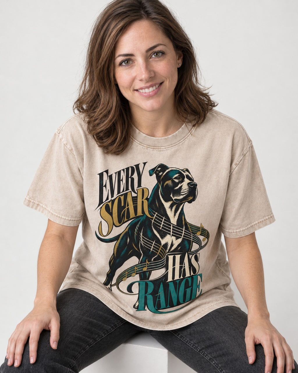Every Pitbull Scar Has Range Washed Tee in Apricot, worn by a seated model