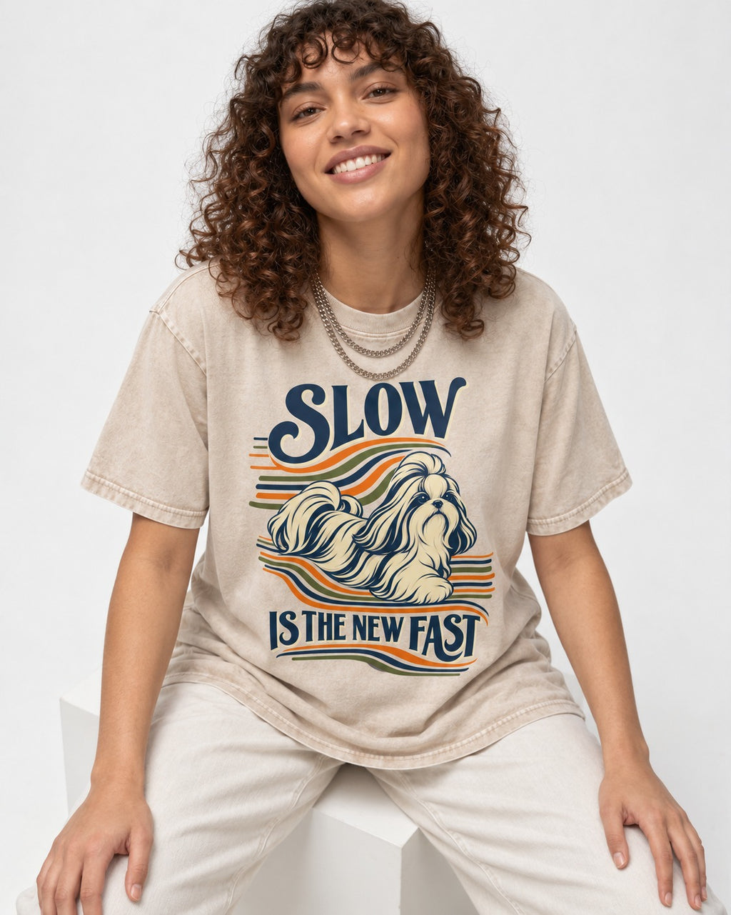 Slow Is Fast Shih Tzu Washed Tee in Apricot, worn by a seated model