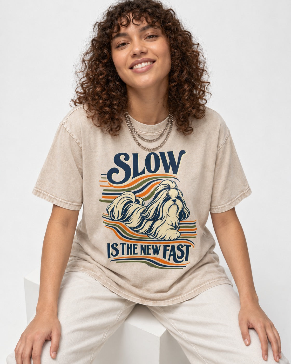 Slow Is Fast Shih Tzu Washed Tee in Apricot, worn by a seated model