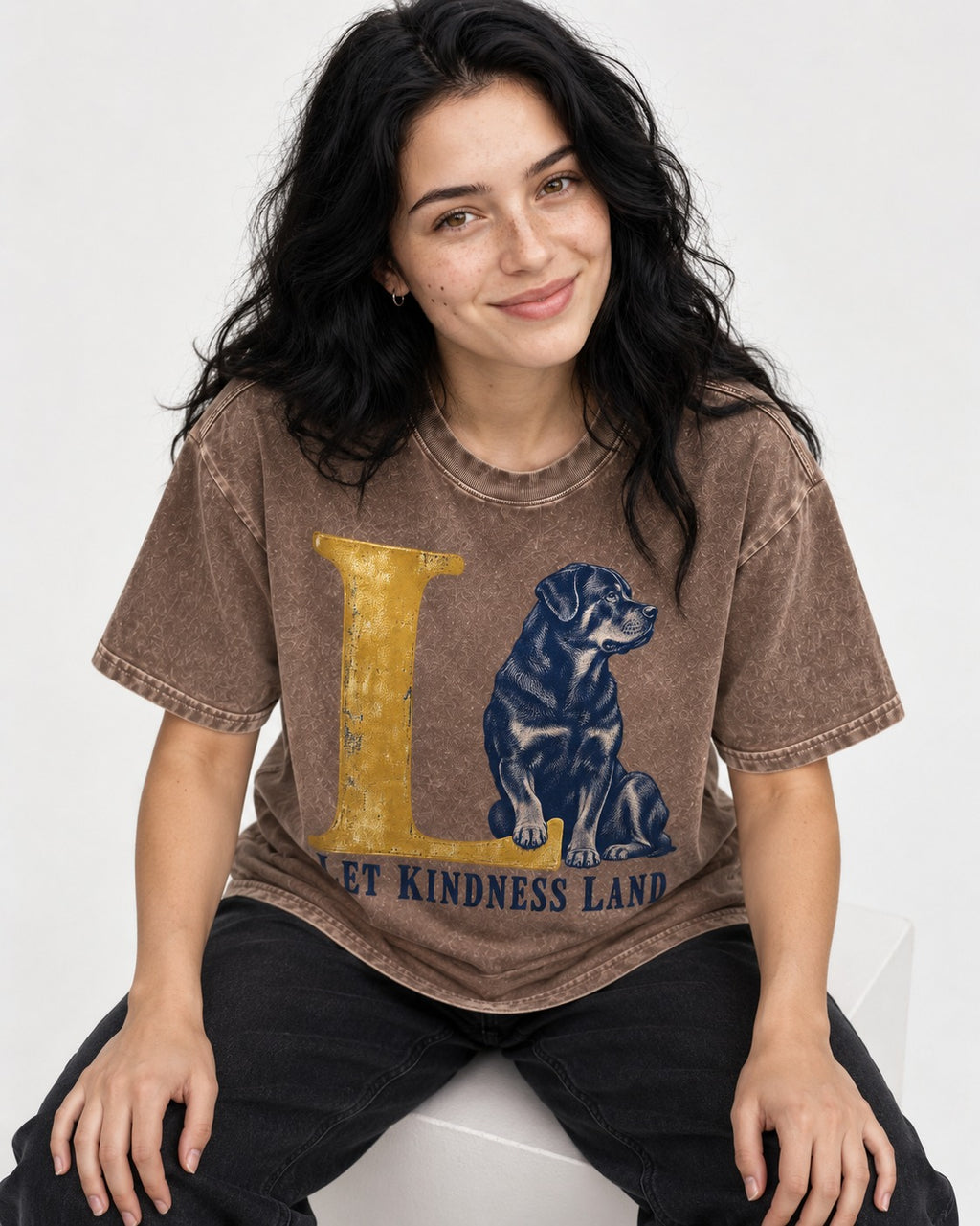 Let Kindness Lead Rottweiler Washed Tee in Coffee, worn by a seated model