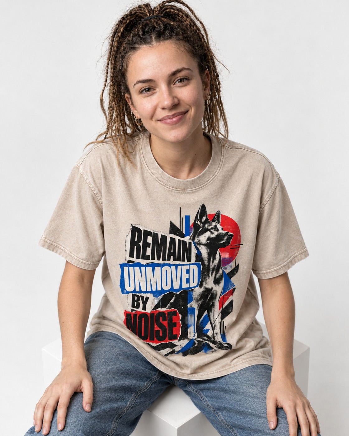 Remain Unmoved By Noise Brutalist Collage German Shepherd Dog Graphic Washed Tee in Apricot, worn by a seated model