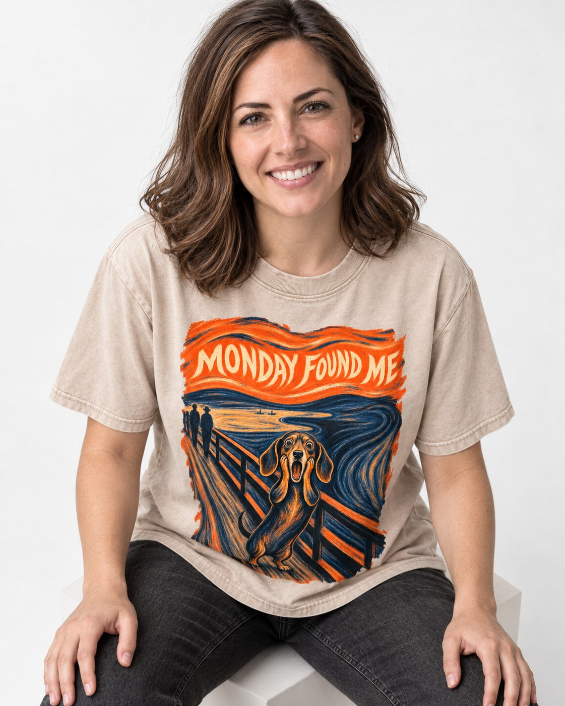 Dachshund Monday Found Me Scream Poster Washed Tee in Apricot, worn by a seated model