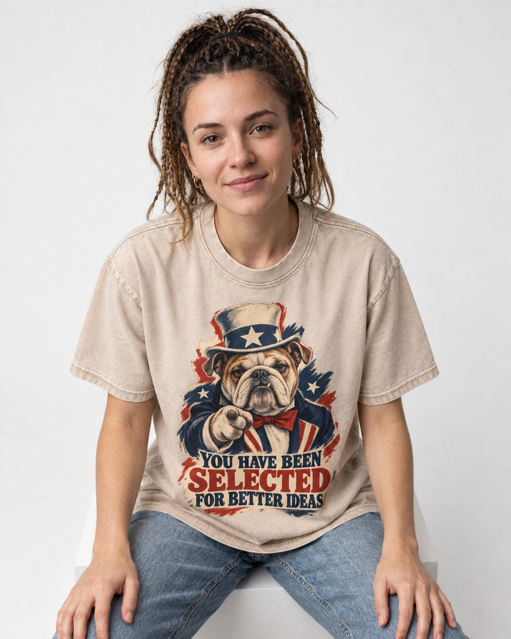 English Bulldog Selected for Better Ideas Washed Tee in Apricot, worn by a seated model